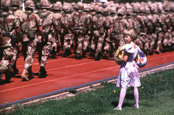 A little girl looks for her uncle in a sea of desert camouflage.